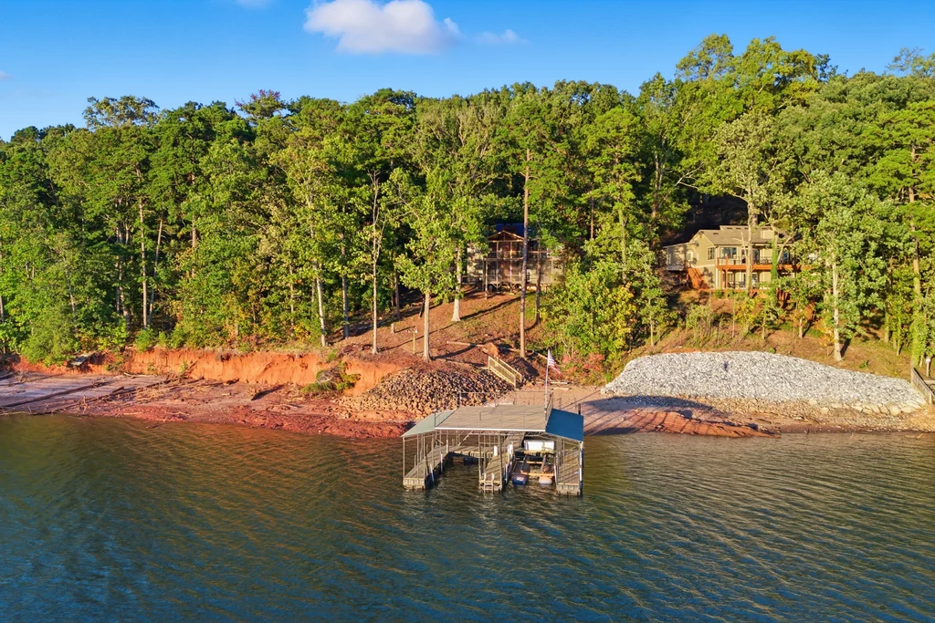Drone view of the private dock with the home in the trees behind it at 5685 Cherokee Trace
