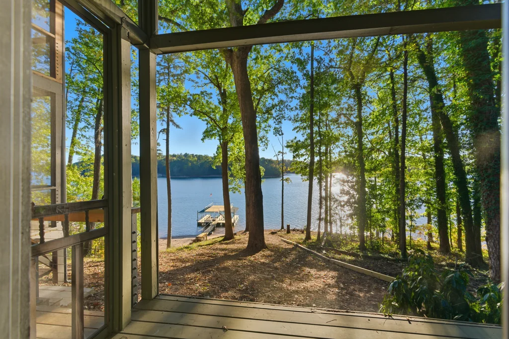 Screened porch looking through the trees to the dock and Lake Lanier