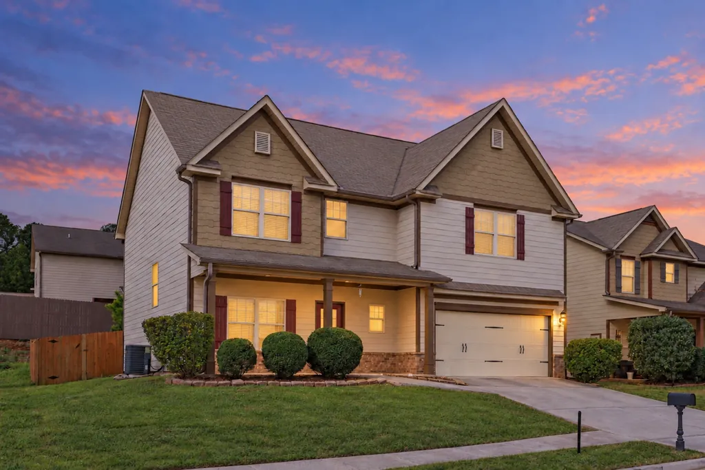 Two-story home with a front porch at 394 Easley Drive, Lawrenceville, at twilight