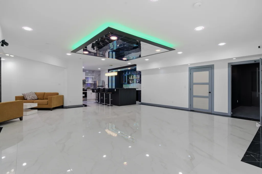 Basement entertainment level with a marble dance floor under a green-lit mirrored ceiling at 7605 Poppy Mill Lane, Cumming